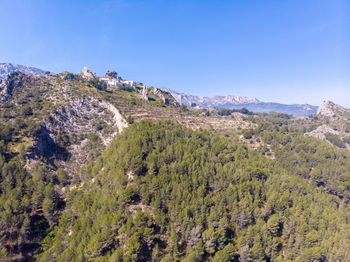 Scenic view of mountains against clear blue sky