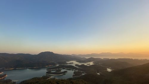 Scenic view of mountains against clear sky during sunset