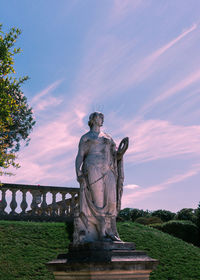Statue against sky at sunset