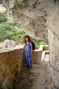 Portrait of woman standing on rock