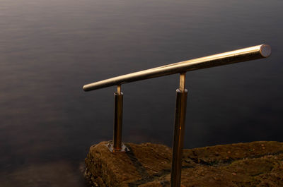 High angle view of wooden railing by lake