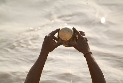 Midsection of woman holding ice cream against sky