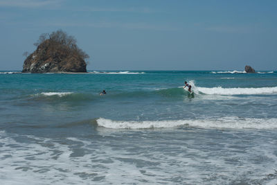 People surfing in sea