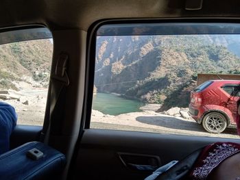 Man seen through car window