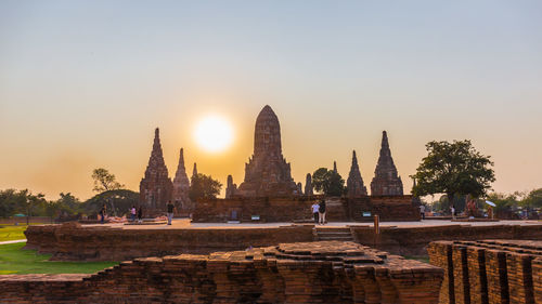 Temple against buildings at sunset