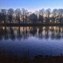 Scenic view of lake against sky at sunset