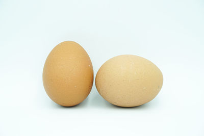 Close-up of eggs against white background