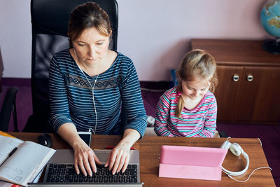 Woman mother working doing her job remotely during video chat call stream online course