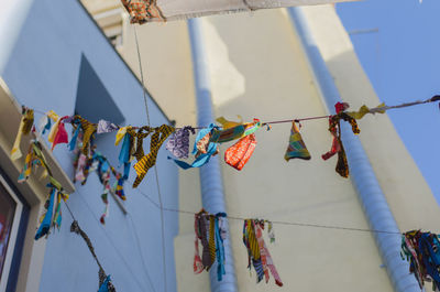 Low angle view of clothesline against buildings