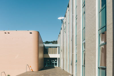 Low angle view of building against clear blue sky