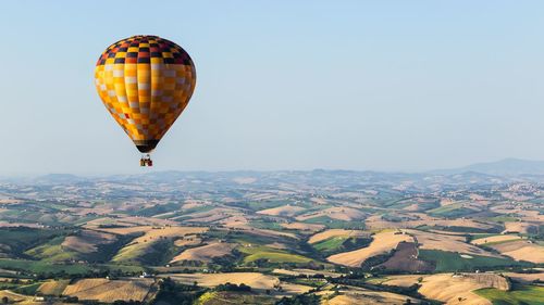 Hot air balloon flying above landscape