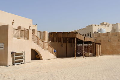 Buildings in city against clear sky