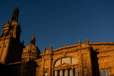 Low angle view of historic building against clear blue sky