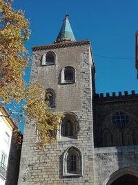 Low angle view of bell tower against sky