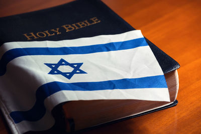 High angle view of flag and bible on table
