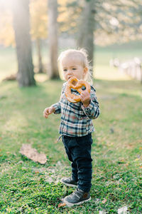 Portrait of cute girl standing on field