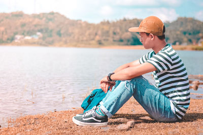 Boy sitting on shore