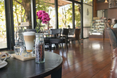 Glass of coffee late on the wood table in coffee shop.