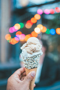 Close-up of hand holding ice cream cone