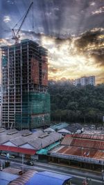 Buildings against cloudy sky