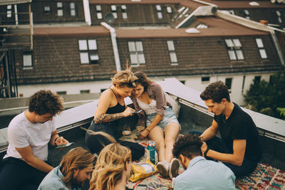 People sitting in front of traditional building