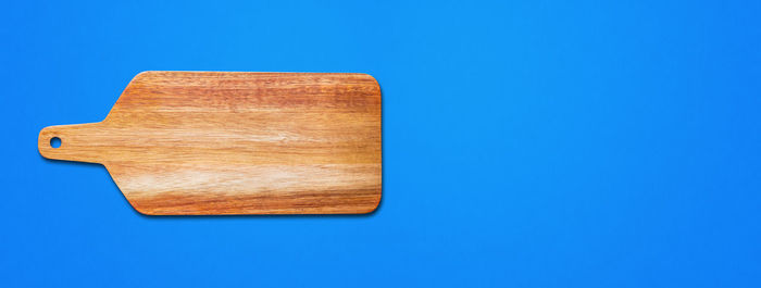 Directly above shot of wooden table against blue sky