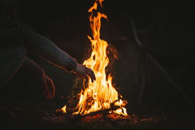 High angle view of man gesturing against campfire