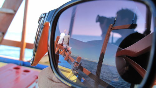 Close-up of hand holding sunglasses