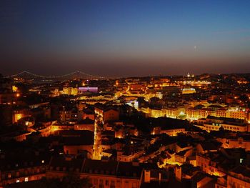 Aerial view of city lit up at night