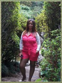 Portrait of smiling woman standing against trees