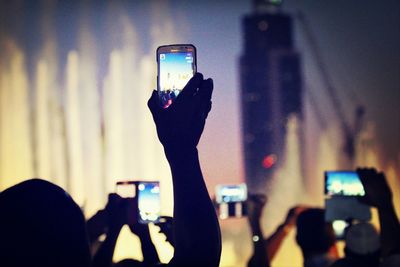 Woman photographing at night