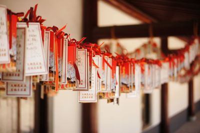 Close-up of fortune papers hanging in temple