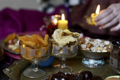 Close-up of illuminated candles on table