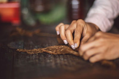 Close-up of man preparing food on table