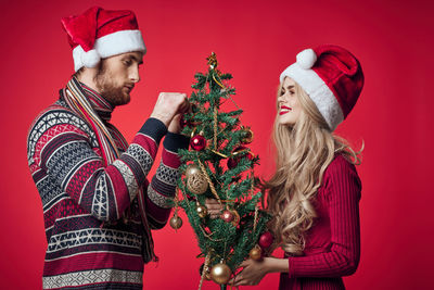 Midsection of man with christmas tree during winter