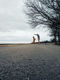 Man standing with dog on road