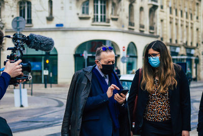 Women standing on street in city