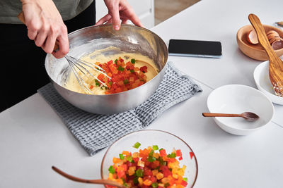 Woman in the kitchen cooking a cake. hands beat the dough with mixer