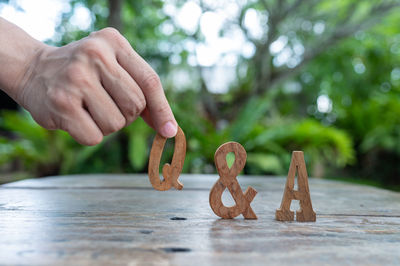 Close-up of hand holding ice cream on table