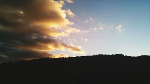 Silhouette of landscape against sunset sky