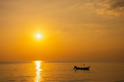 Black silhouette, beautiful sunset with a fishing boat, mae ramphueng beach rayong province thailand