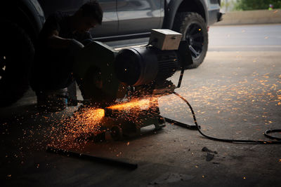 Man working on fire hydrant at night