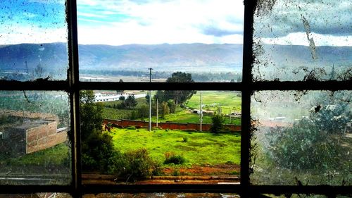 Scenic view of landscape seen through window