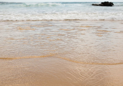 Close-up of surf on beach