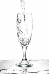 Close-up of wineglass against white background