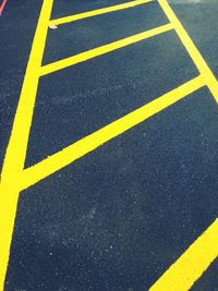 High angle view of yellow road marking at parking lot