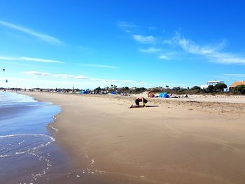 Scenic view of beach against blue sky