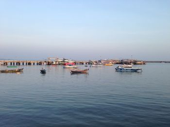 Boats moored in sea against sky