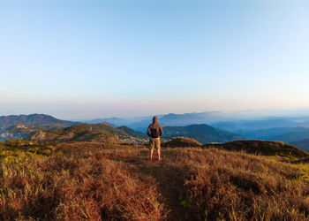 Rear view of man standing on mountain