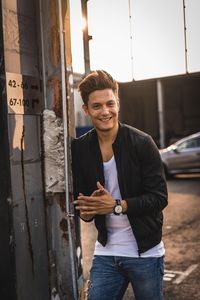 Portrait of smiling young man standing outdoors